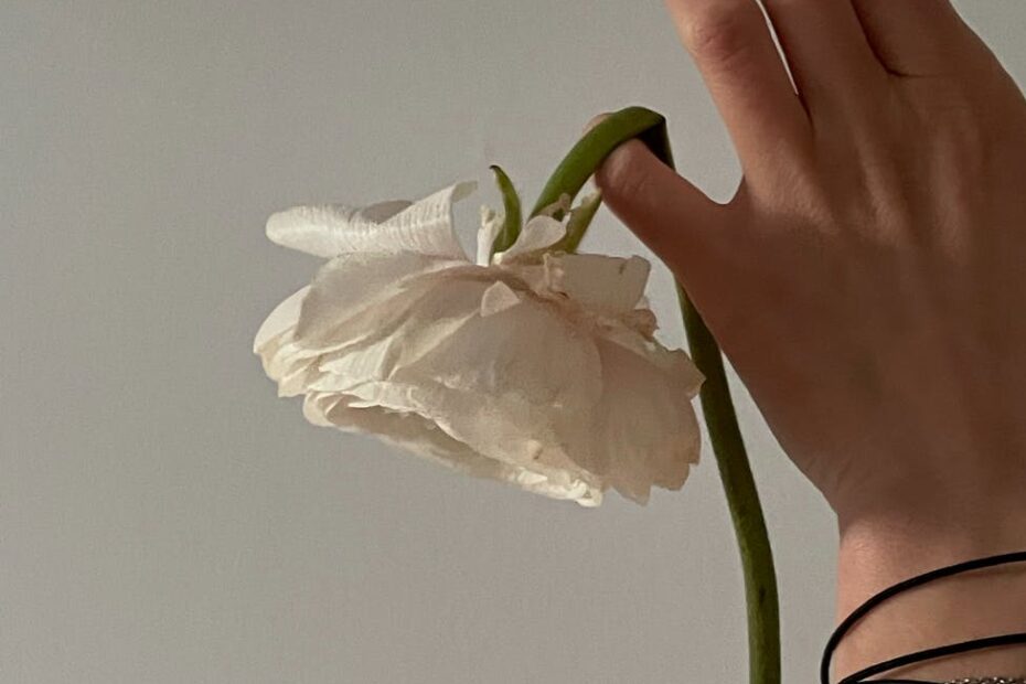 woman showing tender flower with broken stem