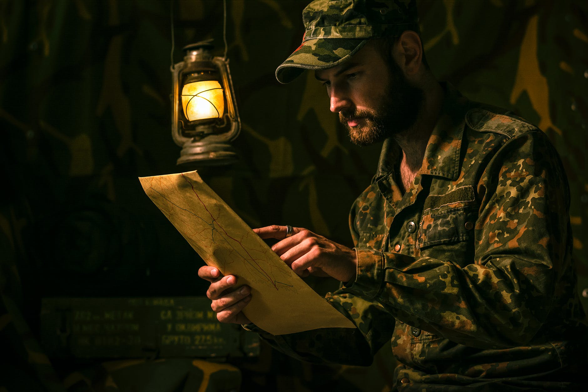 man in military uniform holding a map
