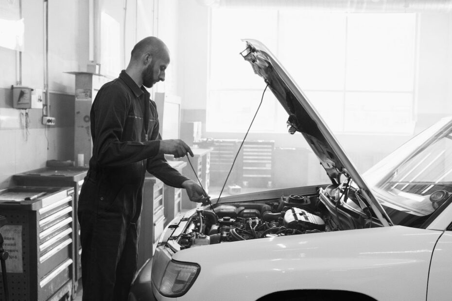 a man in uniform checking a car